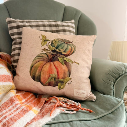 vintage pumpkin decorative pillow cover with a botanical-style pumpkin illustration in warm autumn colors a eucalyptus green velour English armchair.