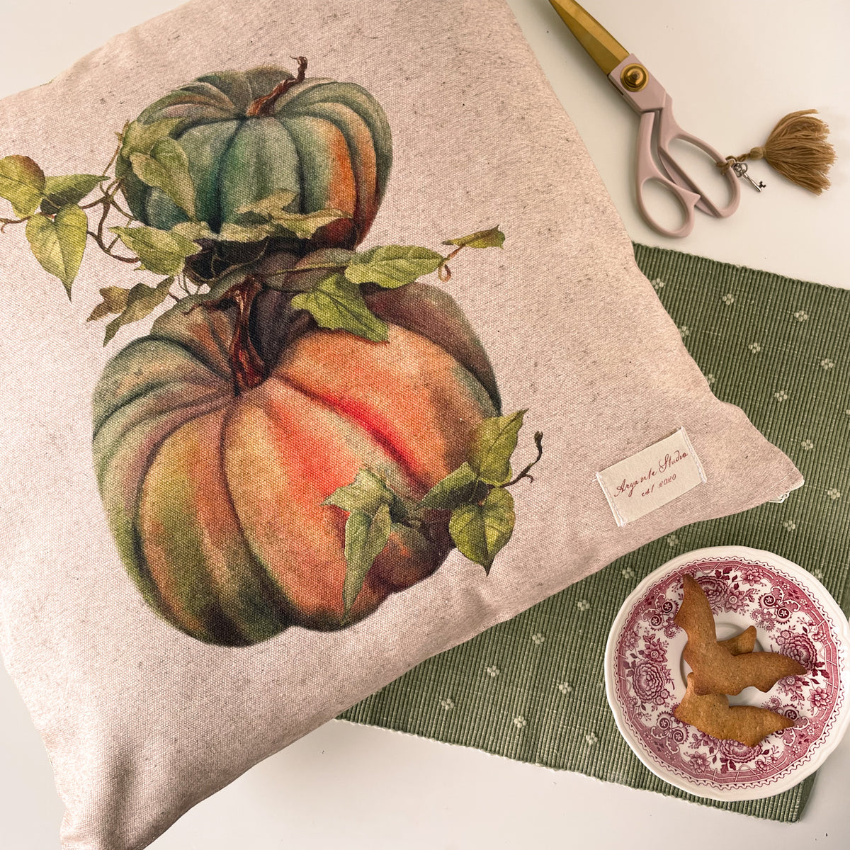 vintage pumpkin decorative pillow cover with a botanical-style pumpkin illustration in warm autumn colours.